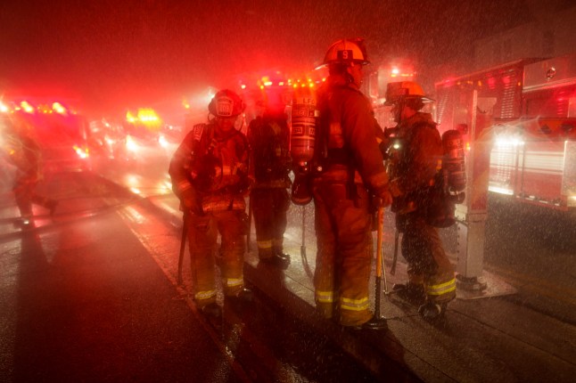 LOS ANGELES, CALIFORNIA - JANUARY 7: Firefighters stage during the Palisades Fire on January 7, 2025 in the Pacific Palisades neighborhood of Los Angeles, California. Fueled by intense Santa Ana Winds, the Palisades Fire has grown to over 2,900 acres and nearly 30,000 people have evacuated while a second fire has emerged near Eaton Canyon. (Photo by Eric Thayer/Getty Images)