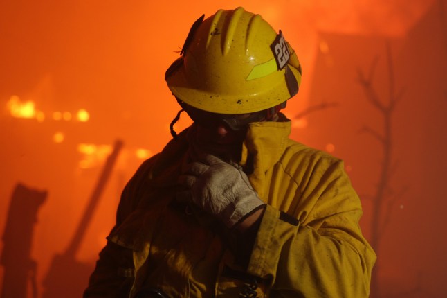 epa11812499 A firefighter reacts from smoke during the Palisades wildfire in Pacific Palisades, Los Angeles, California, USA, 07 January 2025. According to the National Weather Service, large portions of the Los Angeles area are under extreme wildfire risk from 07 to 08 January due to high winds and dry conditions. EPA/ALLISON DINNER