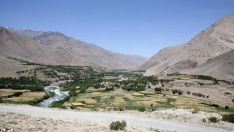 A file picture of the Sangin valley in Afghanistan with arid mountains in the background and a fertile valley in the foreground eiqtieiqkinv