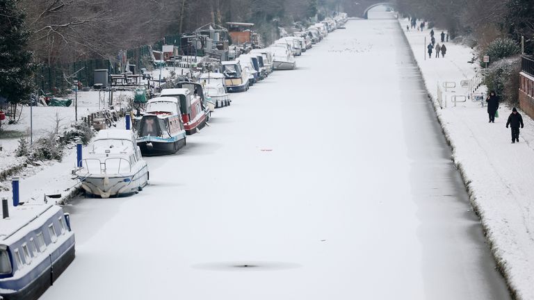 People walk along the towpath of a frozen and snow-covered section of the Bridgewater Canal in Manchester.
Pic: Reuters eiqrridtzirdinv