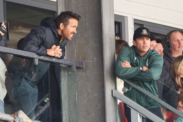 WREXHAM, WALES - MARCH 25: Wrexham AFC owners Ryan Reynolds and Rob McElhenney watch their team during the Vanarama National League match between Wrexham and York City at the Racecourse Ground on March 25, 2023 in Wrexham, Wales. (Photo by Matthew Ashton - AMA/Getty Images)