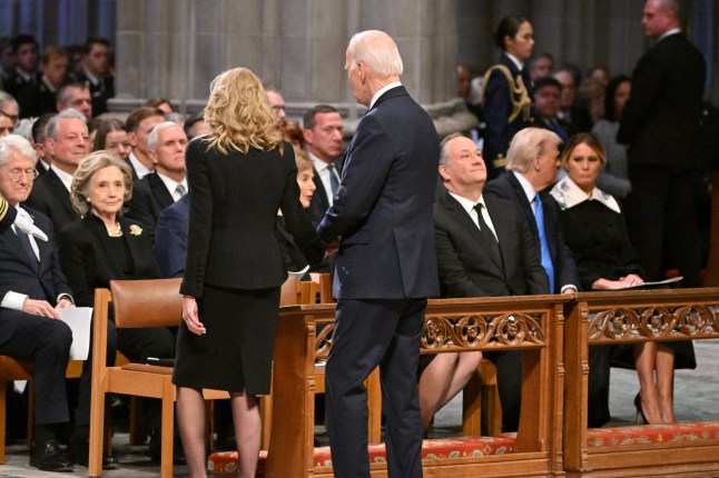 US President Joe Biden and First Lady Jill Biden arrive to take their seats at the State Funeral Service for former US President Jimmy Carter at the Washington National Cathedral in Washington, DC, on January 9, 2025. (Photo by ROBERTO SCHMIDT / AFP) (Photo by ROBERTO SCHMIDT/AFP via Getty Images)