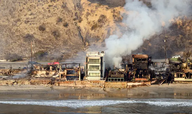 In this aerial view taken from a helicopter, burned homes are seen from above during the Palisades fire in Malibu, Los Angeles county, California qhiddeiqzhiqthinv