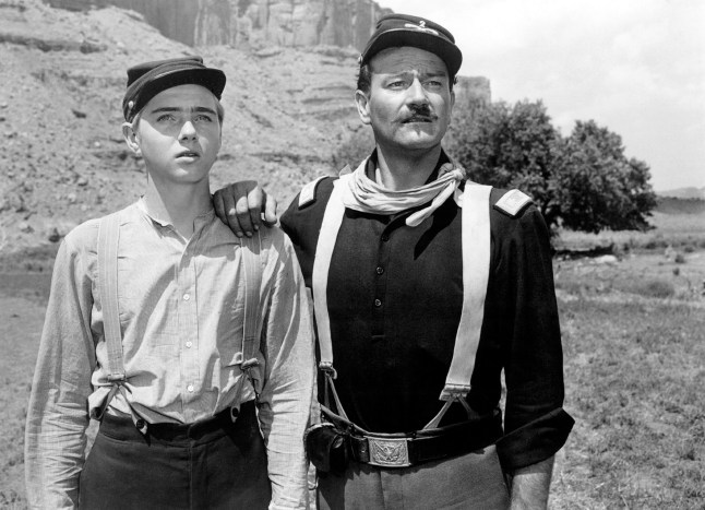 American actors Claude Jarman Jr. and John Wayne on the set of Rio Grande, directed by John Ford. (Photo by Sunset Boulevard/Corbis via Getty Images)