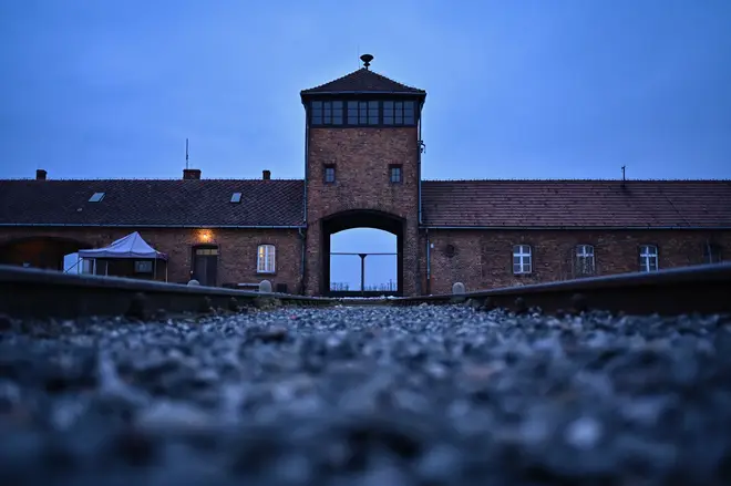 A view of the main entrance and train track at the former Nazi death camp Auschwitz Birkenau qhiqqkiqquierinv