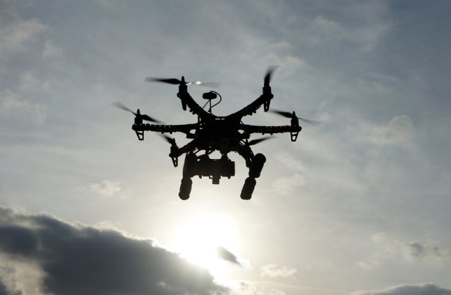 Hexacopter taking aerial photos at sunset. Also known as a drone or UAV (Unmanned Aerial Vehicle). qhiqqkiuriqhzinv