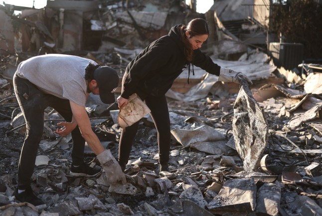 PASADENA, CALIFORNIA - JANUARY 11: Congregants search through the remains of Pasadena Jewish Temple & Center, which served Pasadena for over 100 years and was destroyed in the Eaton Fire, as wildfires cause damage and loss through the LA region on January 11, 2025 in Pasadena, California. Multiple wildfires fueled by intense Santa Ana Winds are burning across Los Angeles County. Reportedly at least 10 people have died with over 180,000 people having been under evacuation orders. Over 9,000 structures have been damaged or burned while more than more than 25,000 acres were burning from the fires. (Photo by Mario Tama/Getty Images)