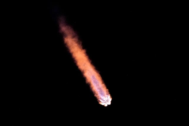 A red rocket tail in the night sky