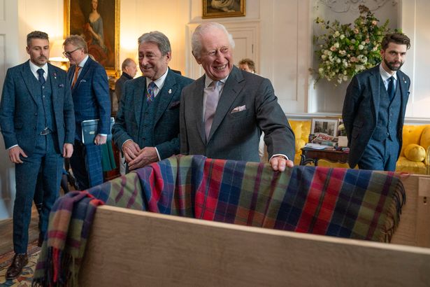 Charles laughs as Sir Rod pretended to throw his watch in the box