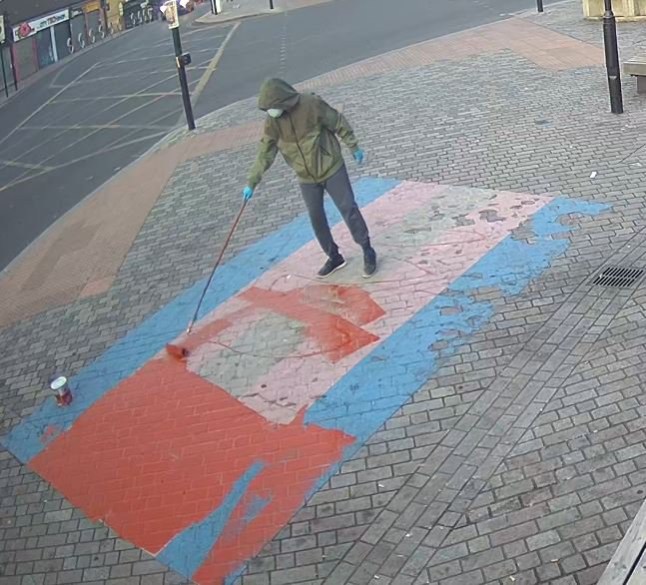 Image released as investigation into Newham Pride flag vandalism continues Detectives who are investigating a linked series of homophobic hate crimes in Newham have released an image of a person they would like to speak to. Police were called early in the morning of Sunday, 23 June after a large painted Pride flag on the pavement outside Forest Gate Railway Station, in Woodgrange Road, E7, had been vandalised. A further report was made on the morning of Wednesday, 26 June regarding criminal damage to two other flags at the same location. All three flags were damaged with red paint. Detective Inspector James Rush from the North East area?s Public Protection team, who is leading the investigation, said: ?We believe that the same person committed these offences, which we now know took place at between 05:00hrs and 05:30 on Sunday, 23 June and at about the same time on Wednesday, 26 June. ?As our investigation continues at pace, we have today issued an image of a person we would like to speak to in connection with the offences. The image was captured on Wednesday, 26 June. ?While the person?s face is covered, we hope that someone who lives or works in the area may recognise the individual from their distinctive clothing. If you think you may recognise the person shown in the image ? maybe they are a customer at your shop, or live nearby ? I would urge you to contact my team. ?I understand providing information to police can be intimidating, but I can reassure the public that any information provided will be handled sensitively. If you would rather provide information anonymously, please contact Crimestoppers.? No arrests have been made and enquiries continue. Anyone with information can contact police by calling 101 or visiting www.met.police.uk, quoting reference 2433/23Jun. Alternatively, you can call the independent charity Crimestoppers anonymously on 0800 555 111 or visit crimestoppers-uk.org. qhiquqiqkqihxinv