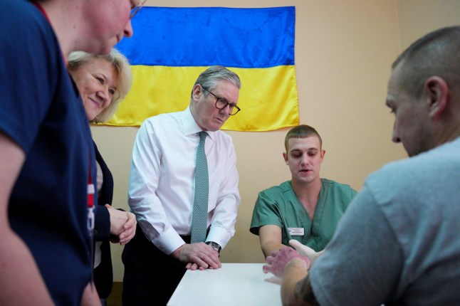 Prime Minister Sir Keir Starmer visits a hospital in Kyiv as staff members tend to an injured patient, a Ukrainian service member, during his visit to Ukraine to sign a new long-term partnership deal with Volodymyr Zelensky. The 100 Year Partnership includes defence and scientific collaboration but will also forge new community links between the UK and Ukraine. Picture date: Thursday January 16, 2025. PA Photo. See PA story POLITICS Ukraine. Photo credit should read: Carl Court/PA Wire