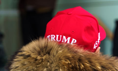 A person photographed from behind is wearing a Maga hat with ‘Trump’ written across the back