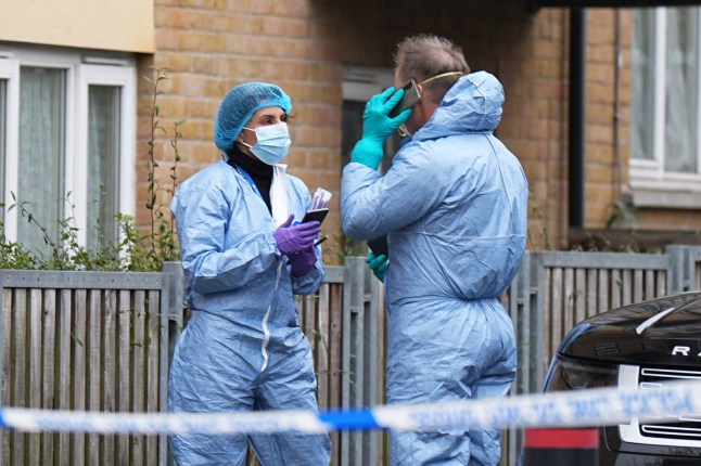 A forensic officers where mum Michelle Sadio was shot in Willesden, London.