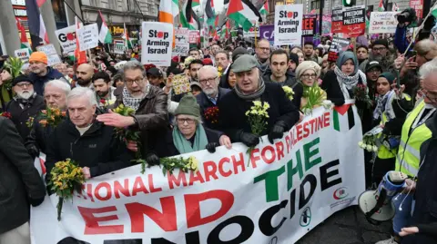 PA Media Protestors, including Jeremy Corbyn and John McDonnell, march through London