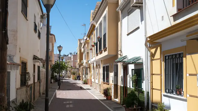 Residential properties on a street in the Pedregalejo Playa area in Malaga, Spain. qhiddkiqeriqqtinv