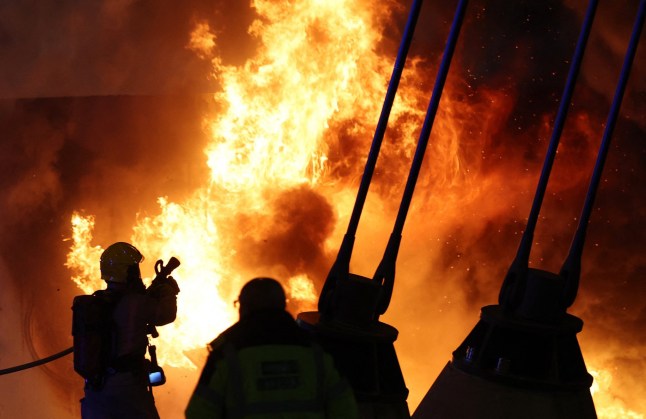 Soccer Football - Champions League - Manchester City v Club Brugge - Etihad Stadium, Manchester, Britain - January 29, 2025 Firefighters attend to a fire in a merchandise hut outside the stadium before the match REUTERS/Phil Noble