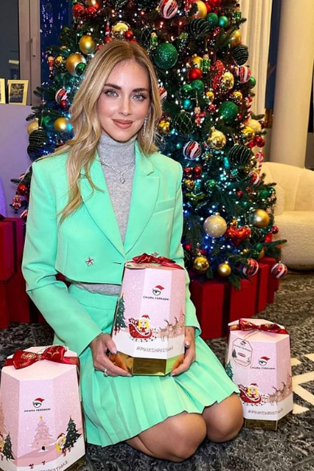 A social media post shows Ferragni, 36, holding the special edition cake she created in a pink box as she kneels in front of a Christmas tree qhiddqiqxqireinv