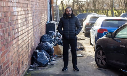 Mohammed Shafqat among the fly-tipping and discarded cars on Camelot Way.