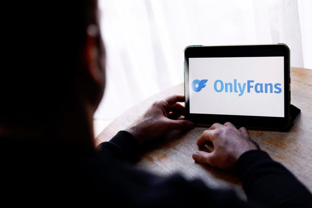 Image of a man accessing OnlyFans on a mobile device