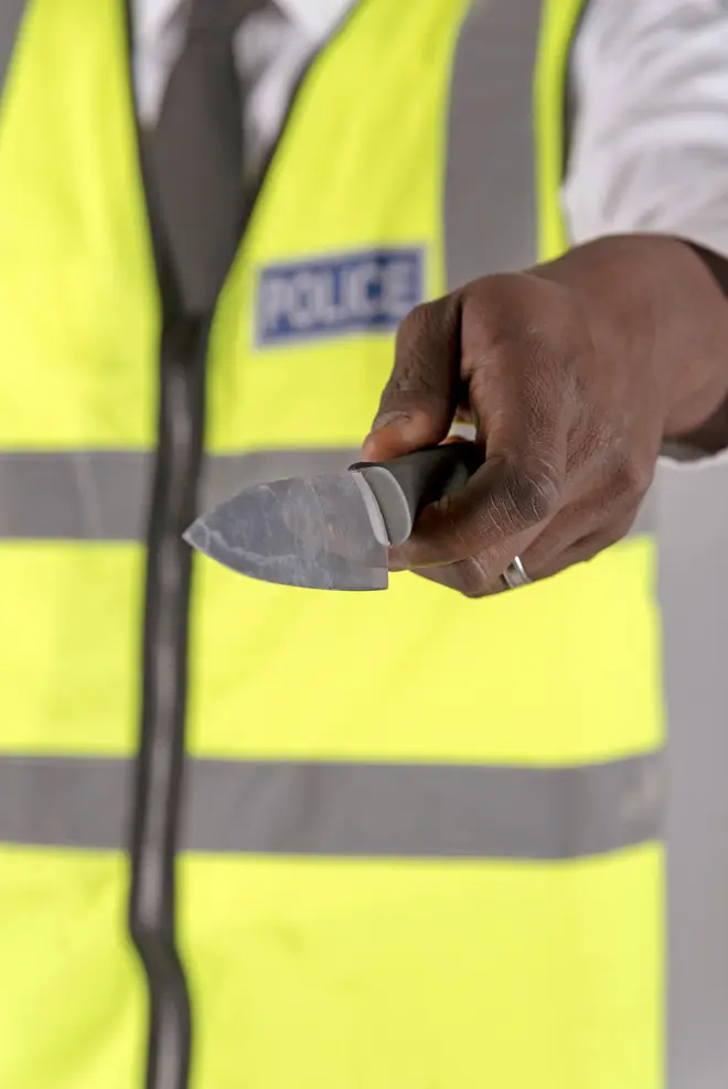 Salisbury, Wiltshire, UK. April 2019. Police officer holding a siezed kitchen knife