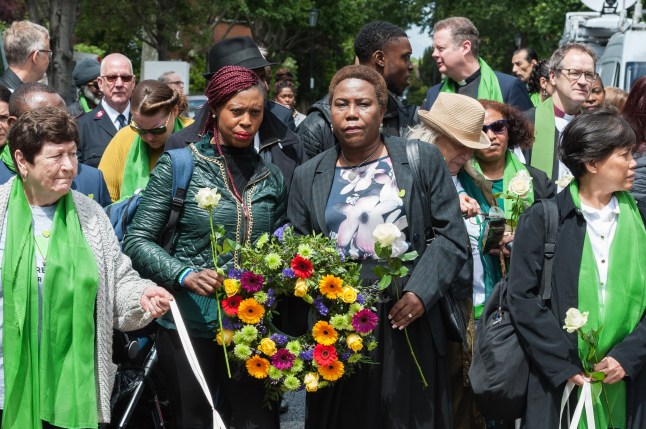 LONDON, UNITED KINGDOM - JUNE 14: Survivors, bereaved families, members of the public and community leaders gather outside St. Helen’s Church in London to take part in the ’Humanity for Grenfell’ commemorations on 14 June, 2019, marking the second anniversary of the Grenfell Tower fire, which took the lives of 72 people two years ago. (Photo credit should read Wiktor Szymanowicz/Future Publishing via Getty Images) qhiddzidzxidqhinv