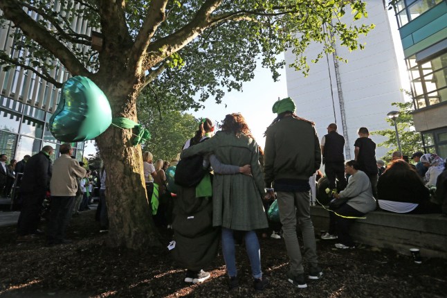 LONDON, ENGLAND - JUNE 14: Family and friends of the 72 people who lost their lives in the Grenfell Tower block fire gather outside Grenfell Tower, London, for a wreath laying ceremony to mark the two-year anniversary, on June 14, 2019 in London, England. June 14 will mark two years since a fire ripped through the 24-story apartment building, killing 72 people, the largest loss of life in Britain since World War II. The event highlighted several fire-safety issues in London’s high-rises, particularly the use of aluminum-and-plastic cladding that proved highly flammable in the Grenfell blaze. (Photo by Isabel Infantes - WPA Pool/Getty Images)