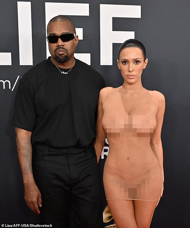 Kanye West has claimed his wife Bianca Censori can’t wear anything without his approval as he responded to the backlash over their outrageous Grammys stunt