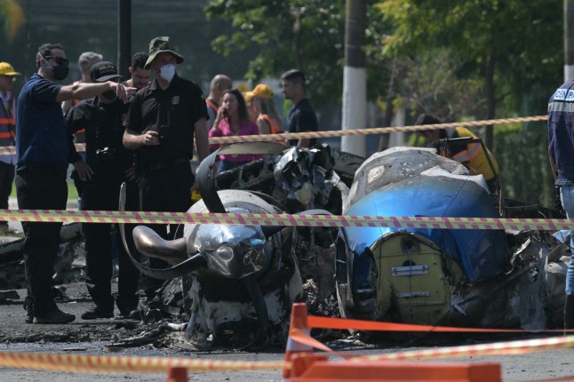 Police investigadors work at the site of a plane accident in Sao Paulo, Brazil, on February 7, 2025. A plane plunged into a major avenue in the Brazilian city of Sao Paulo on Friday and exploded after hitting a bus, leaving two people dead and six injured, officials said. (Photo by NELSON ALMEIDA / AFP) (Photo by NELSON ALMEIDA/AFP via Getty Images) eiqekiqruiqqqinv