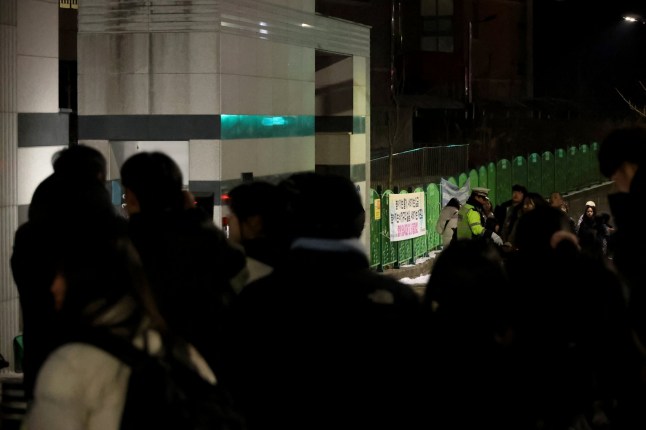 People gather outside an elementary school building in Daejeon, 160 kilometers south of Seoul, on February 10, 2025. A teacher stabbed an eight-year-old student to death at an elementary school in South Korea on February 10, 2025, local media reported, citing authorities. (Photo by YONHAP / AFP) / - South Korea OUT / NO ARCHIVES - RESTRICTED TO SUBSCRIPTION USE (Photo by -/YONHAP/AFP via Getty Images) eiqetidqeiqquinv