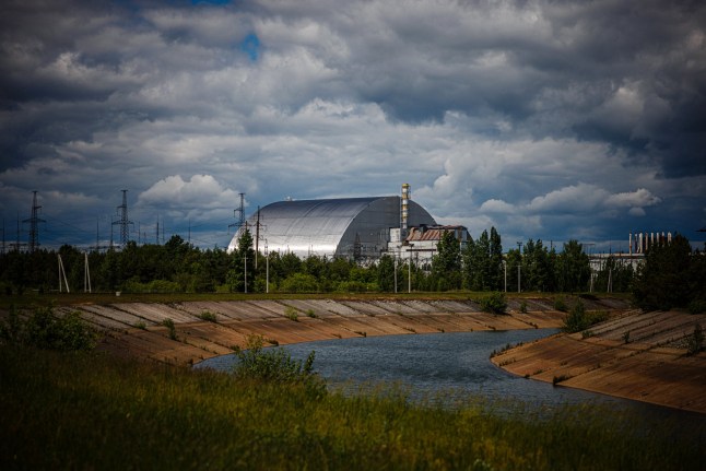 (FILES) A photograph shows the New Safe Confinement at Chernobyl Nuclear Power Plant which cover the number 4 reactor unit on May 29, 2022, amid the Russian invasion of Ukraine. Ukraine’s President Volodymyr Zelensky said on February 14. 2025 that a Russian drone had struck a cover built to contain radiation at the Chernobyl nuclear power plant, adding that 