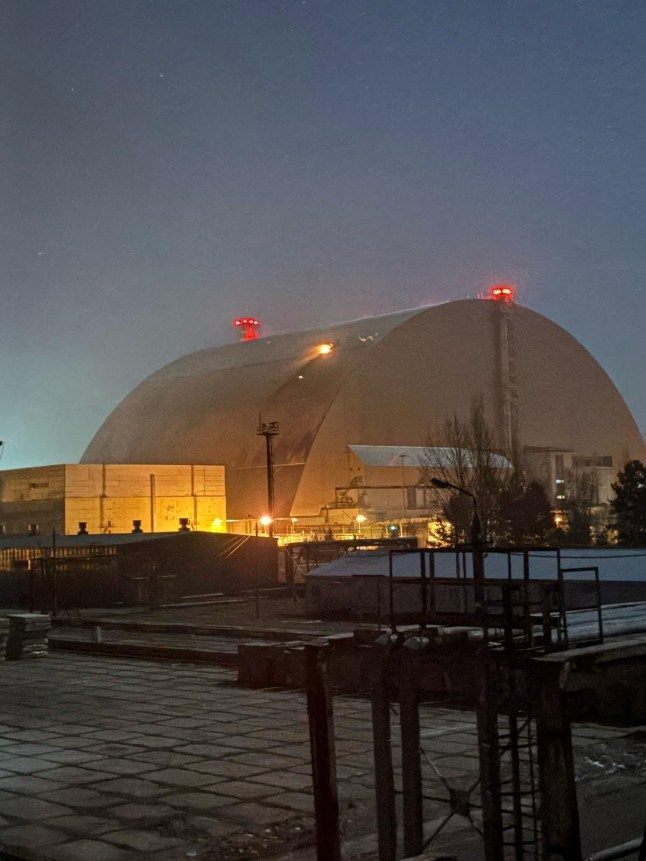 Fire burns on the structure that covers the old sarcophagus which confines the remains of the damaged fourth reactor of the Chornobyl Nuclear Power Plant, after it was hit by what the Ukrainian President Volodymyr Zelenskiy says a Russian drone strike, amid Russia’s attack on Ukraine, at Chornobyl, in Kyiv region, Ukraine February 14, 2025. IAEA/Handout via REUTERS ATTENTION EDITORS - THIS IMAGE HAS BEEN SUPPLIED BY A THIRD PARTY.