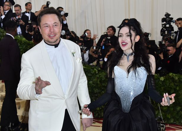 Elon Musk and Grimes arrive for the 2018 Met Gala on May 7, 2018, at the Metropolitan Museum of Art in New York. - The Gala raises money for the Metropolitan Museum of Arts Costume Institute. The Gala’s 2018 theme is Heavenly Bodies: Fashion and the Catholic Imagination. (Photo by ANGELA WEISS / AFP) (Photo credit should read ANGELA WEISS/AFP via Getty Images)