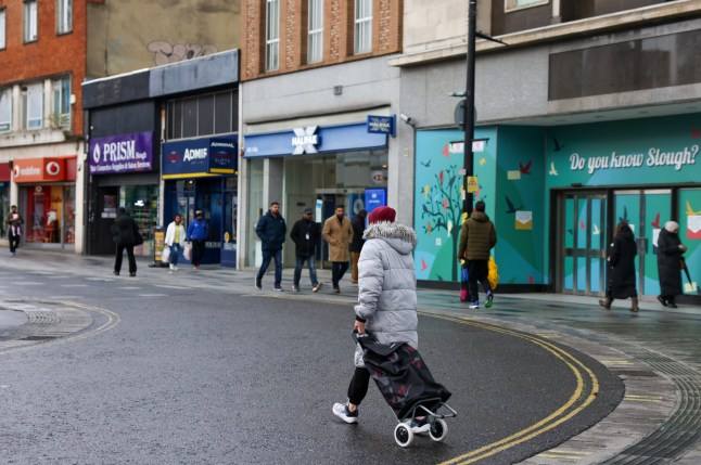 Shoppers walk along the high street in Slough, UK, on Friday, Nov. 10, 2023. The UK economy flatlined in the third quarter, defying forecasts of a small contraction and ensuring a recession is avoided this year, as strong trade came to the rescue of poor domestic activity. Photographer: Hollie Adams/Bloomberg via Getty Images