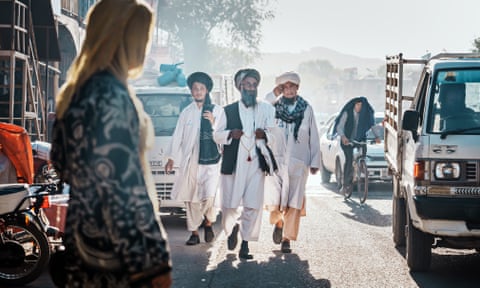 Taliban officials walking down a street