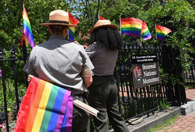 Park rangers place rainbow flags at the Stonewall National Monument, the first LGBTQ national monument, dedicated to the birthplace of modern lesbian, gay, bisexual, transgender, and queer civil rights movement on June 4, 2019 in New York City. - Pride Month 2019 marks The Stonewall 50th Anniversary. (Photo by Angela Weiss / AFP) (Photo credit should read ANGELA WEISS/AFP via Getty Images)