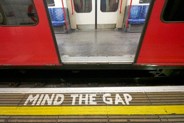 Bank station, Central Line platform. Mind The Gap warning sign to avoid the gap between the train and the platform edge on the London Underground Rail System