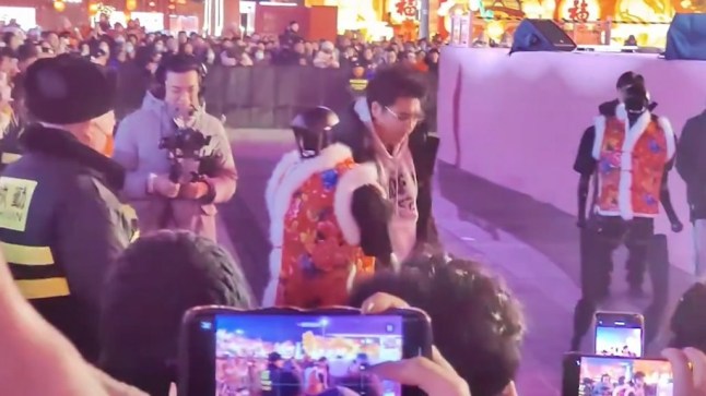 GRABS: 14437625 Chilling moment humanoid robot ’attacks’ crowd and has to be dragged away at Chinese festival